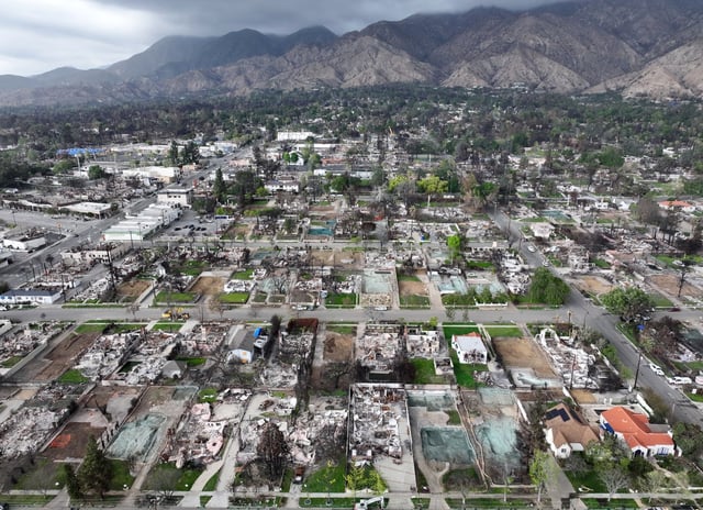 An aerial view of homes destroyed in the Eaton Fire along with lots cleared of debris on March 28, 2025 in Altadena, California. The U.S. Army Corps of Engineers estimates that they have cleared debris from 490 homes destroyed in the Eaton and Palisades Fires so far. Some homeowners are opting to have their lots cleared private contractors. (Photo by Mario Tama/Getty Images)