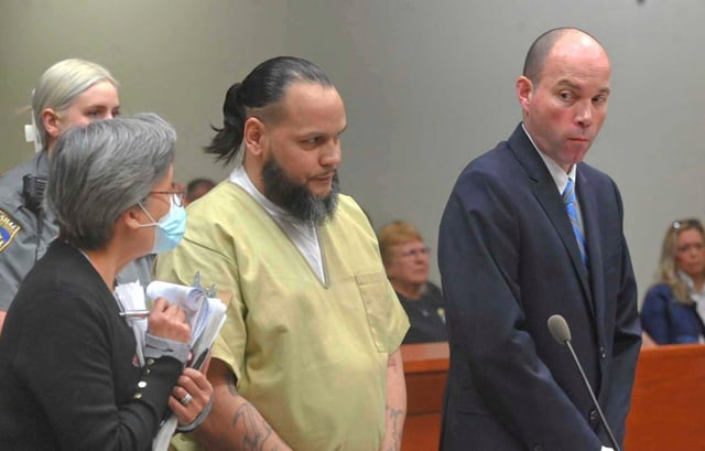 Alex Oyola-Sanchez, center, with his public defender Chris Eddy, right, and a Spanish interpreter during Oyola-Sanchez&#39;s sentencing at state Superior Court in New Britain, Conn., April 29, 2025. (Jim Michaud/Hearst Connecticut Media via AP)