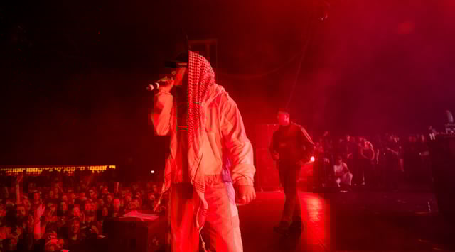 Members of the band Kneecap including Mo Chara and Moglai Bap perform onstage during Day 1 of Coachella on April 18, 2025 in Indio, California. (Scott Dudelson/Getty Images)