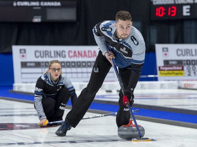 Brett Gallant, right, sweep as Jocelyn Peterman releases a rock against Tyrel Griffith and Nancy Faye Martin in the gold medal game at the Canadian mixed doubles curling championships at Willie O'Ree Place in Fredericton, N.B. on Sunday, March 24, 2019.