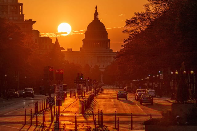 Sunrise behind the U.S. Capitol building illuminates Pennsylvania Avenue early in the morning on October 26, 2024, in Washington, D.C.