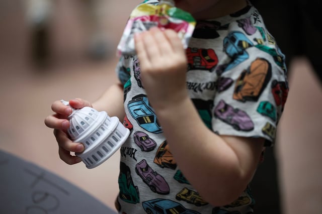 A child holds a dome stress ball during a rally at the Capitol on March 13, 2025 in Washington, D.C.