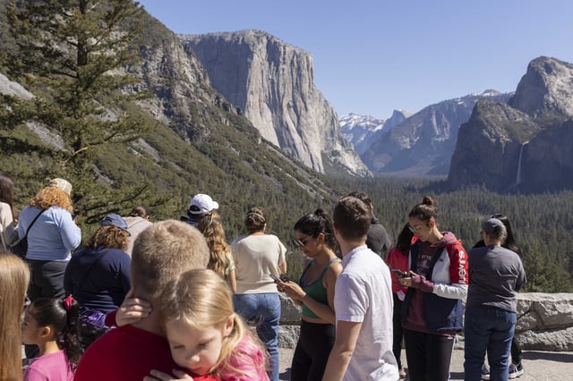 Tourists take in the views at a vista point in Yosemite Valley in March 2022.