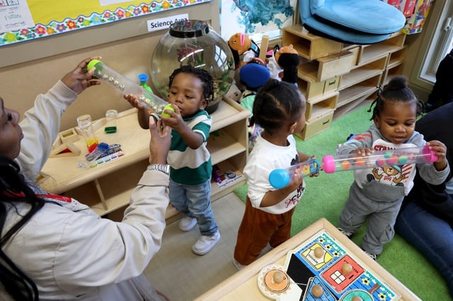 Teacher’s aid Crystal Bennett plays with students in an Early Head Start room at Start Early, Educare Chicago, a nonprofit public-private partnership, on April 8, 2025. (Antonio Perez/Chicago Tribune)