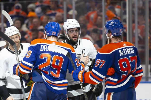 Leon Draisaitl #29 and Connor McDavid #97 of the Edmonton Oilers talk with Anze Kopitar #11 of the Los Angeles Kings during the third period in Game Five of the First Round of the 2024 Stanley Cup Playoffs at Rogers Place on May 1, 2024, in Edmonton, Canada.