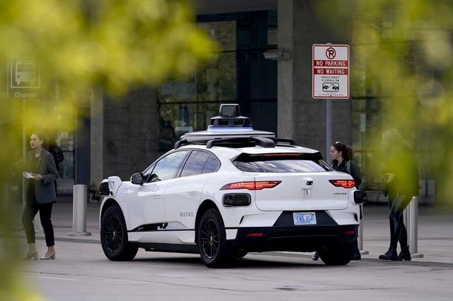 FILE - A Waymo self-driving vehicle sits curbside on Dec. 16, 2022, at the Sky Harbor International Airport Sky Train facility in Phoenix. (AP Photo/Matt York, File)