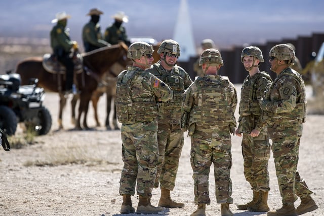 FILE - Army soldiers chat while waiting the arrival of Defense Secretary Pete Hegseth to the US-Mexico border in Sunland Park, N.M., Monday, Feb. 3, 2025. (AP Photo/Andres Leighton, File)