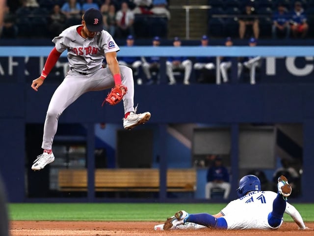 Toronto Blue Jays shortstop Bo Bichette, right, slides into second base with a steal ahead of a tag by Boston Red Sox second baseman Kristian Campbell in first inning MLB action in Toronto on Tuesday, April 29, 2025.