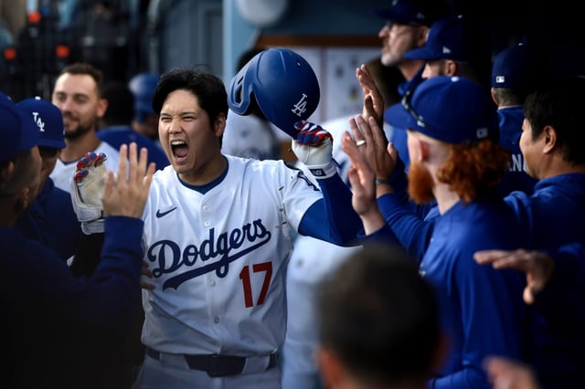 Dodgers star Shohei Ohtani celebrates with teammates in the dugout after hitting a solo home run during the first inning of their game against the Miami Marlins on Tuesday night at Dodger Stadium. The Dodgers collected 18 hits and eight walks in a 15-2 rout. (Photo by Katelyn Mulcahy/Getty Images)