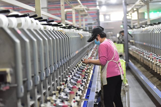 A worker is working in a workshop of a chemical fiber textile enterprise in Qingzhou Economic Development Zone, Shandong Province, China on March 25, 2025.