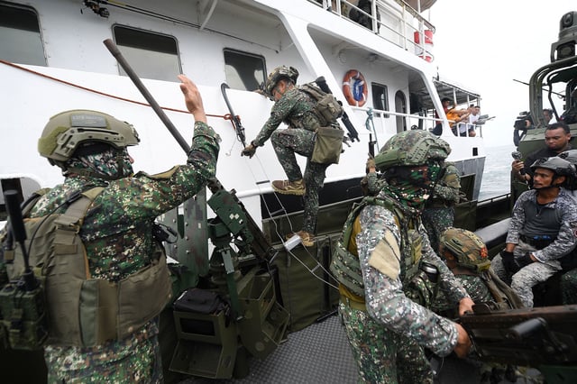 Philippine marines board a ship during a joint visit, board and seizure exercise with their US and South Korean counterparts with members of Japan's Self-Defense Forces as observers, during training in Ternate town, Cavite province, west of Manila, on October 22, 2024.