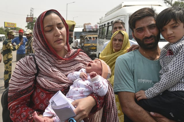 Pakistani national Sara Khan, left, married to Indian citizen Aurangzeb Khan, right, holding their children prepares to leave for Pakistan without her husband from the Attari-Wagah border between India and Pakistan, following New Delhi’s decision to order almost all Pakistani citizens to leave the country after last week’s deadly attack in Indian-controlled Kashmir, Wednesday, April 30, 2025. (AP Photo/Prabhjot Gill)