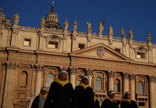 Nuns walk in front of St. Peter's Basilica in St. Peter's Square ahead of the conclave, which will be held on May 7, at the Vatican, April 30, 2025. REUTERS/Stoyan Nenov