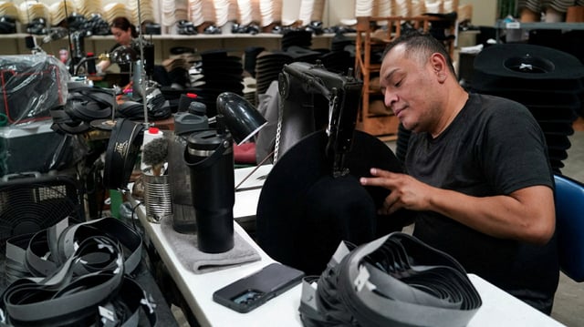 A man works on a hat, where assembly workers for Master Hatters of Texas put the initial and final touches on dozens of cowboy hats, ready to be shipped to customers, in Garland, Texas, U.S., April 14, 2025. REUTERS/Jorge Garcia