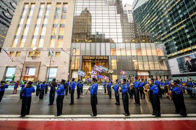 Participants dressed in green and Irish themed costumes march across the Trump Tower during the St. Patrick&#39;s Day Parade on 5th Avenue in Manhattan on March 17, 2025 in New York City.