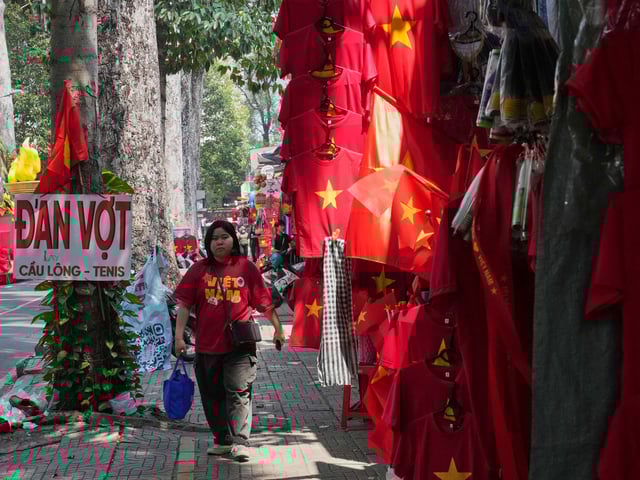 A woman walks after watching a parade celebrating the 50th anniversary of the end of the Vietnam War in Ho Chi Minh City, Vietnam, Wednesday, April 30, 2025. (AP Photo/Achmad Ibrahim)