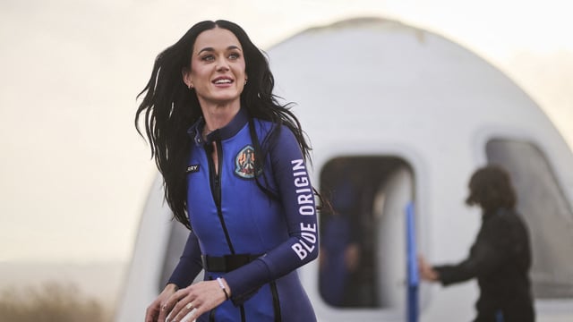 This handout photo from Blue Origin shows US singer Katy Perry upon return to Earth after a flight on Blue Origin New Shepard NS-31, which brought the passengers beyond the Karman line -- the internationally recognized boundary of space, in Van Horn, West Texas, April 14, 2025. 