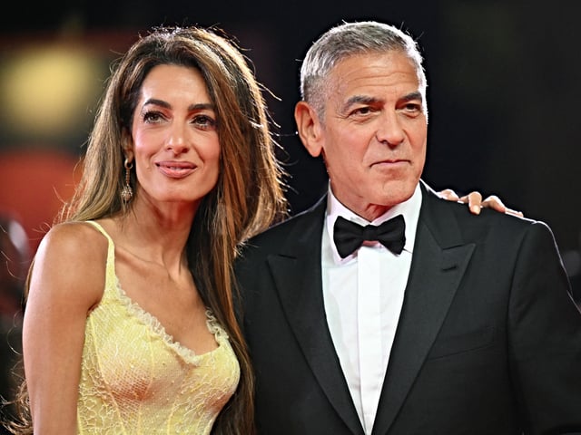 Actor George Clooney and his wife Amal Clooney attend the red carpet of the movie "Wolfs" presented out of competition during the 81st International Venice Film Festival at Venice Lido, on September 1, 2024. (Photo by Alberto PIZZOLI / AFP)