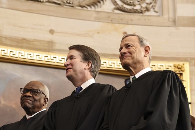 U.S. Associate Supreme Court Justices Clarence Thomas and Brett Kavanaugh and U.S. Supreme Court Chief Justice John Roberts react during inauguration ceremonies in the Rotunda of the U.S. Capitol on January 20, 2025 in Washington, DC.