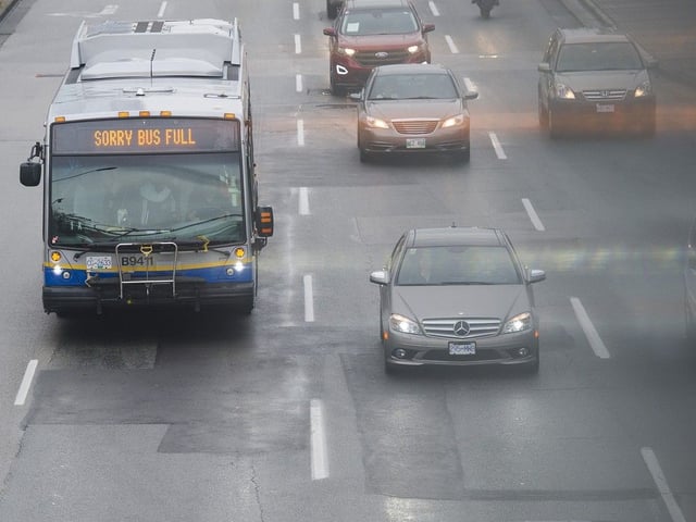 A Translink bus with a " Sorry Bus Full " sign drives along Kingsway.