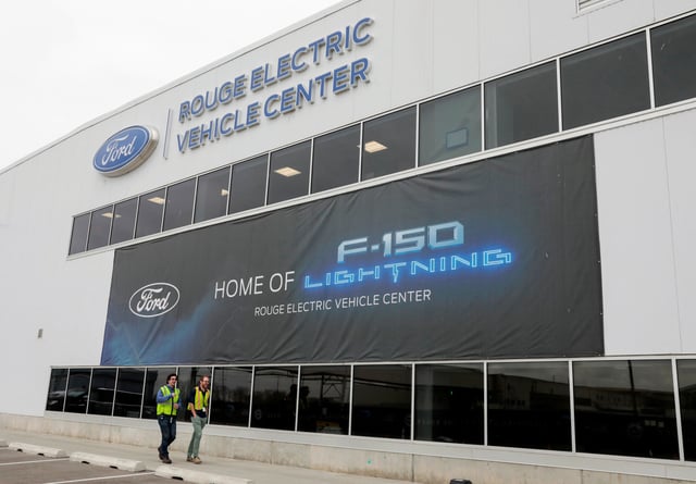 A banner for the all-new Ford F-150 Lightning electric pickup truck is seen outside the Rouge Electric Vehicle Center in Dearborn, Michigan, U.S., April 26, 2022. REUTERS/ Rebecca Cook/File Photo