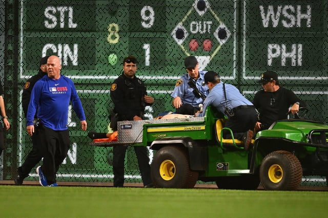 A fan is helped by emergency personnel after falling from the stands during the seventh inning of the game between the Chicago Cubs and the Pittsburgh Pirates at PNC Park, in Pittsburgh, Pa,. on April 30, 2025.