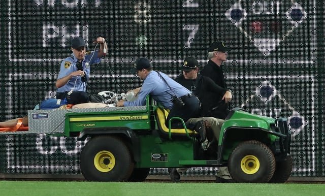 Apr 30, 2025; Pittsburgh, Pennsylvania, USA;  Stadium security and Pittsburgh Pirates medical personnel cart a fan who fell from the stands to the field to an ambulance as the Pirates batted against the Chicago Cubs during the seventh inningat PNC Park. Mandatory Credit: Charles LeClaire-Imagn Images