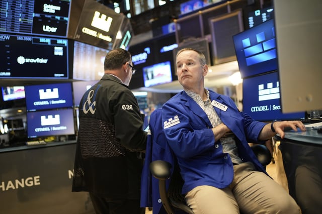 Stephen Naughton works on the floor at the New York Stock Exchange in New York, Wednesday, April 30, 2025. (AP Photo/Seth Wenig)