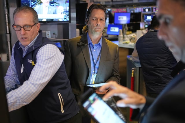 Patrick McKeon, center, works on the floor at the New York Stock Exchange in New York, Wednesday, April 30, 2025. (AP Photo/Seth Wenig)