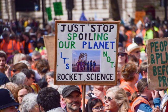 LONDON, UNITED KINGDOM - 2025/04/26: A protester holds a &#39;Just stop spoiling our planet&#39; placard with a picture of Katy Perry and other women who took part in the Blue Origin space flight, as Just Stop Oil activists pass through Parliament Square during their final protest. The climate group recently announced they will cease protest actions. (Photo by Vuk Valcic/SOPA Images/LightRocket via Getty Images)