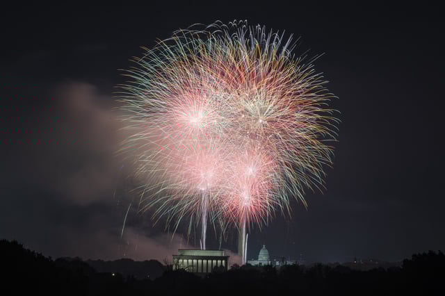 Fireworks go off above Lincoln Memorial, Washington Monument and the US Capitol building during the Independence Day fireworks display in Arlington, Va., on July 4, 2024.