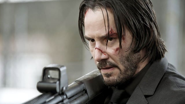 Keanu Reeves shoots a gun in John Wick