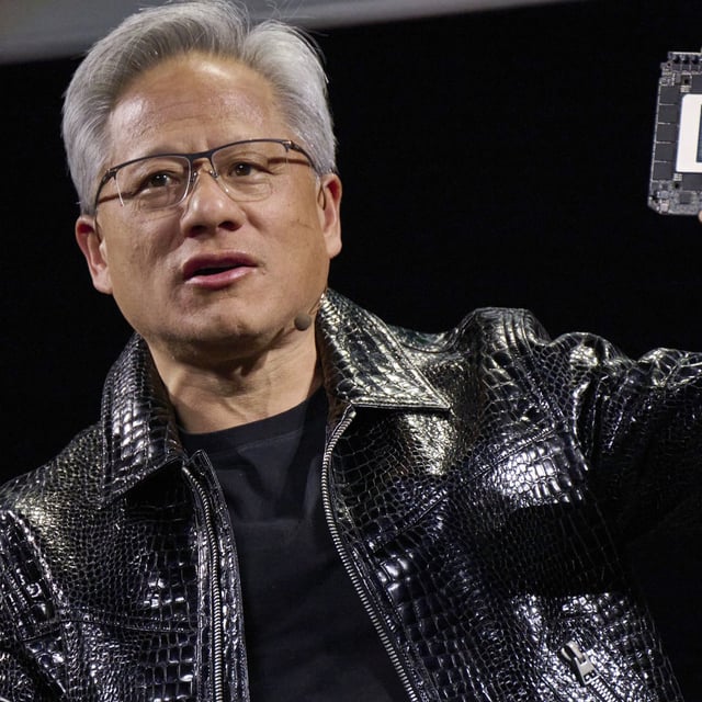 Jensen Huang, co-founder and chief executive officer of Nvidia Corp., speaks while holding the company's new GeForce RTX 50 series graphics cards and a Thor Blackwell robotics processor during the 2025 CES event in Las Vegas, Nevada, US, on Monday, Jan. 6, 2025. Huang announced a raft of new chips, software and services, aiming to stay at the forefront of artificial intelligence computing. Photographer: Bridget Bennett/Bloomberg via Getty Images