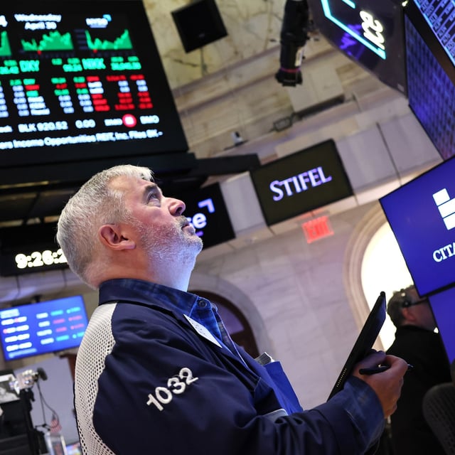 Traders work on the floor of the New York Stock Exchange during morning trading on April 30, 2025.