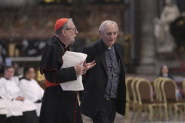 Cardinal Matteo Zuppi, right, talks with Cardinal Claudio Gugerotti prior to the start of a mass on the fifth of nine days of mourning for late Pope Francis, in St. Peter&#39;s Basilica at the Vatican, Wednesday, April 30, 2025.