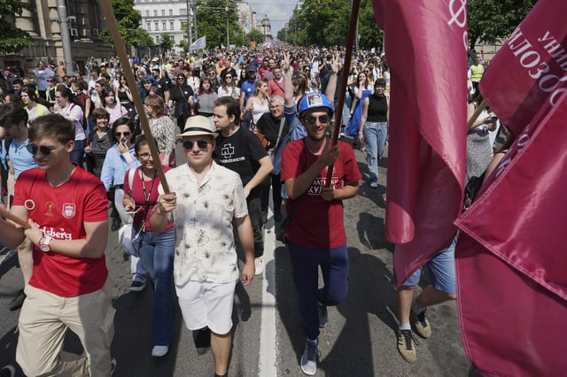 University students and people protest in front of the government building, six months after the deadly train station tragedy that sparked mass demonstrations against corruption, in Belgrade, Serbia, Thursday, May 1, 2025. (AP Photo/Darko Vojinovic)