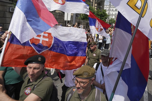 Military veterans protest in front of the government building, six months after the deadly train station tragedy that sparked mass demonstrations against corruption, in Belgrade, Serbia, Thursday, May 1, 2025. (AP Photo/Darko Vojinovic)