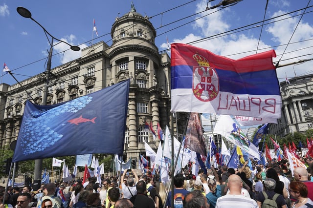 University students and people protest in front of the government building, six months after the deadly train station tragedy that sparked mass demonstrations against corruption, in Belgrade, Serbia, Thursday, May 1, 2025. (AP Photo/Darko Vojinovic)
