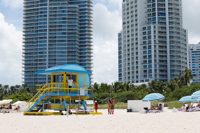A lifeguard tower sits on the beach on a sunny day in front of the Continuum On South Beach luxury condos on August 16, 2023, in Miami Beach, Florida.