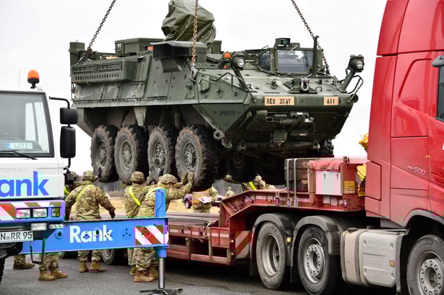 U.S. Army soldiers with 2nd Squadron, 2nd Cavalry Regiment load a Stryker armored vehicle onto a truck at Rose Barracks Air Field, before a deployment to Romania in Vilseck, Germany, February 9, 2022.  U.S. Army/Gertrud Zach/Handout via REUTERS/File Photo