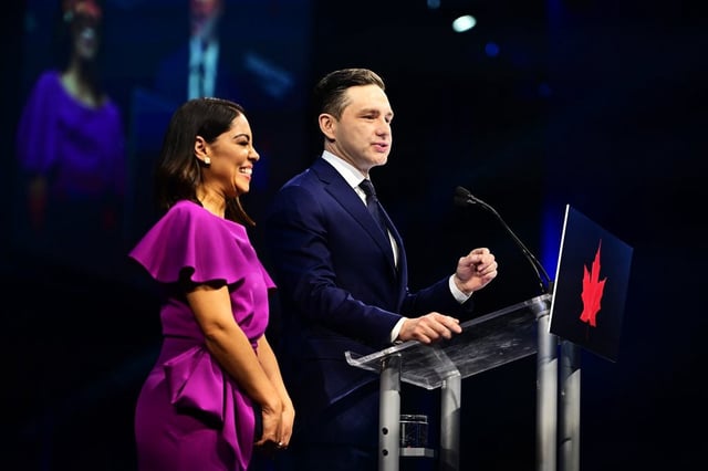 Conservative Leader Pierre Poilievre speaks to supporters with his wife Anaida Poilievre at his campaign headquarters on election night in Ottawa on Tuesday, April 29, 2025. 