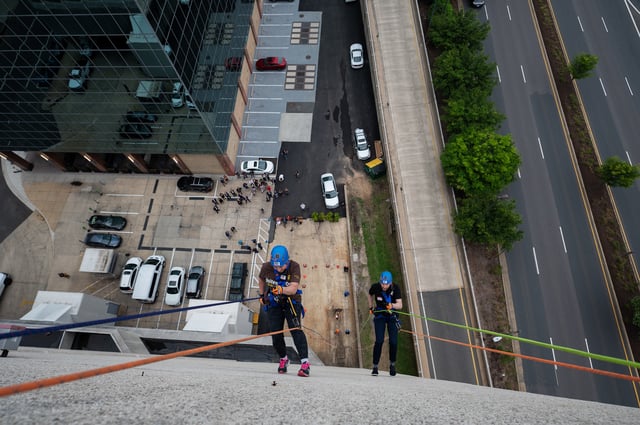 ARLINGTON, VA- MAY 05: Rosemary Hughes with UPS Community Relations and Charles Hill, General Manager of the Hilton, rappel from the roof of the Crystal City Hilton in Arlington, VA on May 05, 2022. The event was put on by the fundraising group Over the Edge to raise money and awareness for New Hope Housing, a nonprofit dedicated to ending homelessness in Northern Virginia. (Photo by Craig Hudson for The Washington Post via Getty Images)