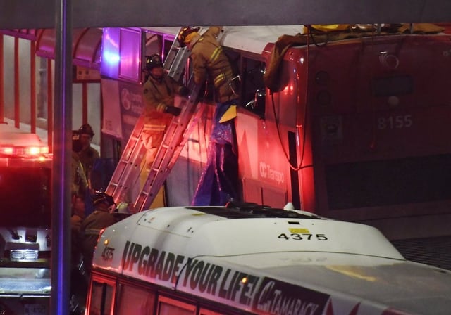 Firefighters work at the scene where a double-decker city bus struck a transit shelter in Ottawa,  Jan. 11, 2019. THE CANADIAN PRESS/Justin Tang