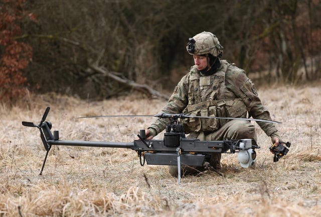 A soldier of a UAS (Unmanned Aircraft System) platoon of the U.S. Army 3rd Brigade, 10th Mountain Division, readies a Anduril Ghost-X helicopter surveillance drone for take-off during the Combined Resolve 25-1 military exercises at the Hohenfels Training Area in Bavaria on February 3, 2025 near Hohenfels, Germany.