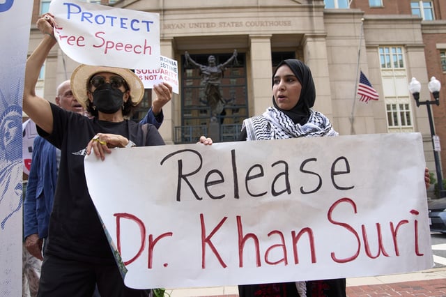 Mapheze Saleh, right, wife of arrested and detained Georgetown University scholar Badar Khan Suri, holds a sign calling for her husband's release after speaking at a news conference following his hearing at Federal District Court for the Eastern District of Virginia, in Alexandria, Va., Thursday, May 1, 2025. (AP Photo/Jacquelyn Martin)