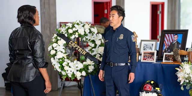 Athena Grant and Chimney Han standing in front of Bobby Nash's memorial in 9-1-1 Season 8