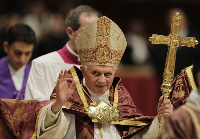 FILE - Pope Benedict XVI blesses the faithful as he arrives at St. Peter's Basilica in the Vatican, Dec. 16, 2010. (AP Photo/Alessandra Tarantino, File)