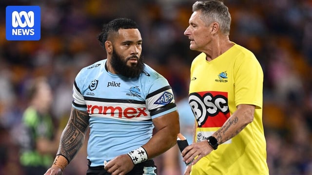 Sifa Talakai looks at a Cronulla Sharks trainer while walking off the field.