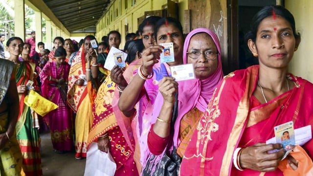 People wait to cast their votes during the panchayat elections at Baraigram in Karimganj, Assam, on Friday. (PTI Photo)
