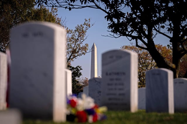 ARLINGTON, VIRGINIA - NOVEMBER 11: The Washington Monument is visible through grave stones at Arlington National Cemetery on Veterans Day on November 11, 2024 in Arlington, Virginia. Veterans Day is held on the anniversary of the end of World War I and honors all veterans of the US Armed Forces. (Photo by Andrew Harnik/Getty Images)
